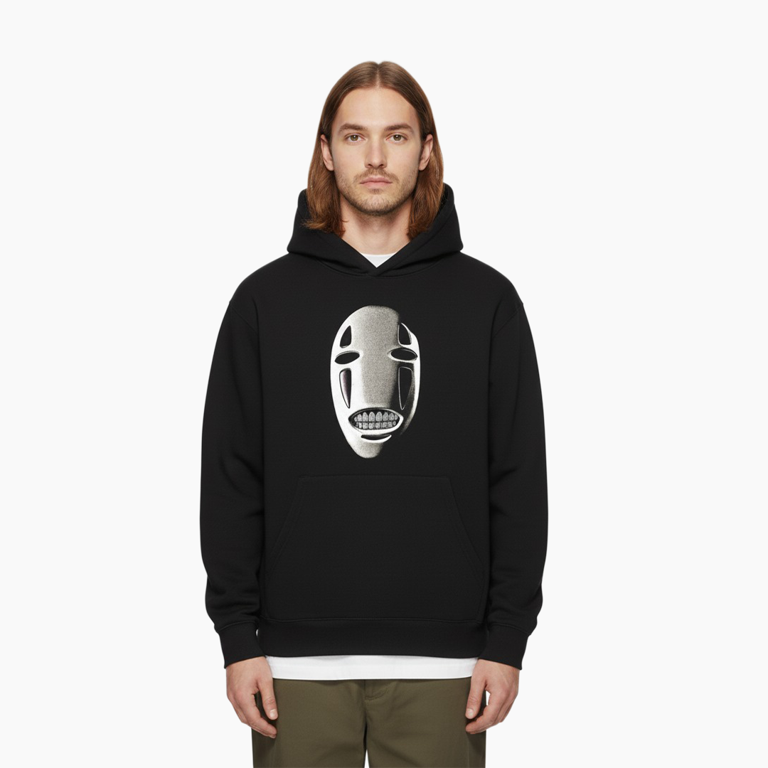 Person wearing a black hoodie with a white mask design on a white background