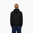 Person wearing a black hoodie on a white background