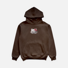 Brown hoodie featuring a graphic print on the middle front chest of a skeleton cats head with a pink bowtie and diamond grillz.